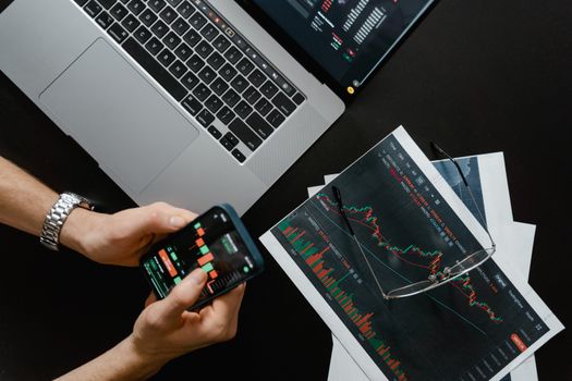 Professional financial advisor looking at multiple computer screens