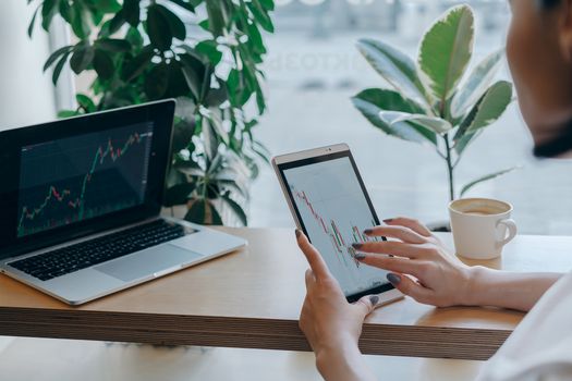 Minimalist desk setup with a laptop and a notebook showing financial data