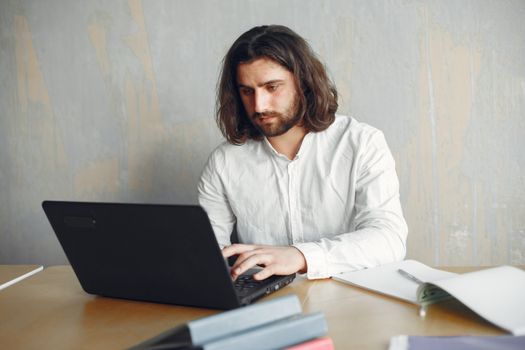A focused freelancer working at a clean desk with insurance policy documents spread out