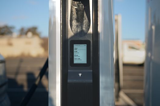 EV charging card tapped against public DC fast charger screen