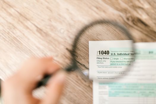 Taxpayer reviewing W-2 wage form next to computer keyboard