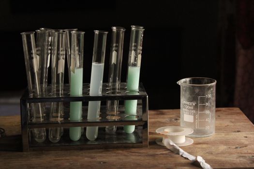 pouring white vinegar from glass measuring cup into sink drain