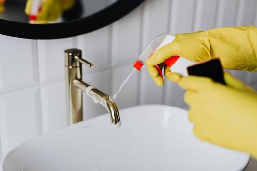 person using red cup plunger on bathroom sink drain