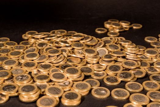 Comparison of two different stack of coins on a glass table representing financial choices