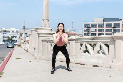 beginner demonstrating incorrect knee valgus collapse during squat descent