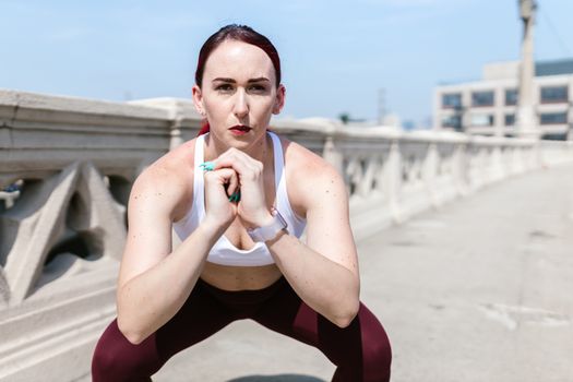 beginner performing bodyweight squat with neutral spine in gym