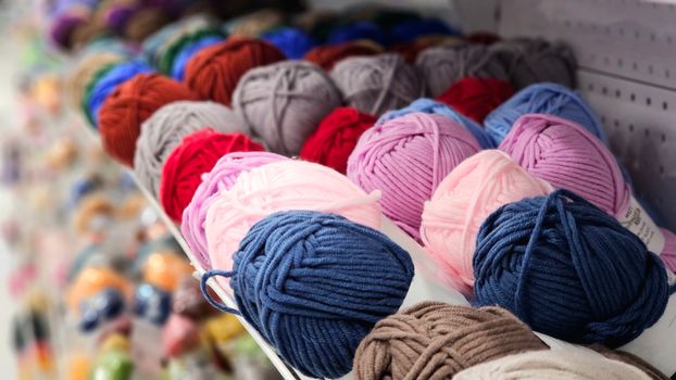 digital yarn yardage calculator app open on a smartphone next to a ball of wool yarn