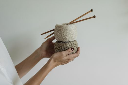 skeins of colorful merino wool yarn displayed on a wooden retail shelf with price tags